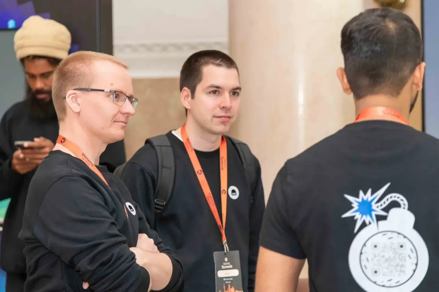 Teilnehmer mit Lanyards im Dialog beim Sonic Summit Event – Eventfotografie Wien dokumentiert Networking-Momente