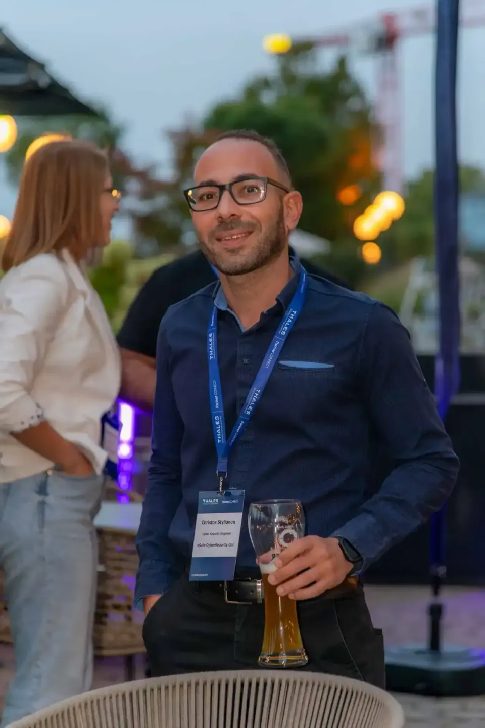 Professioneller Eventfotograf Wien dokumentiert Gast mit Namensschild beim Thales Firmenevent in entspannter Abendatmosphäre