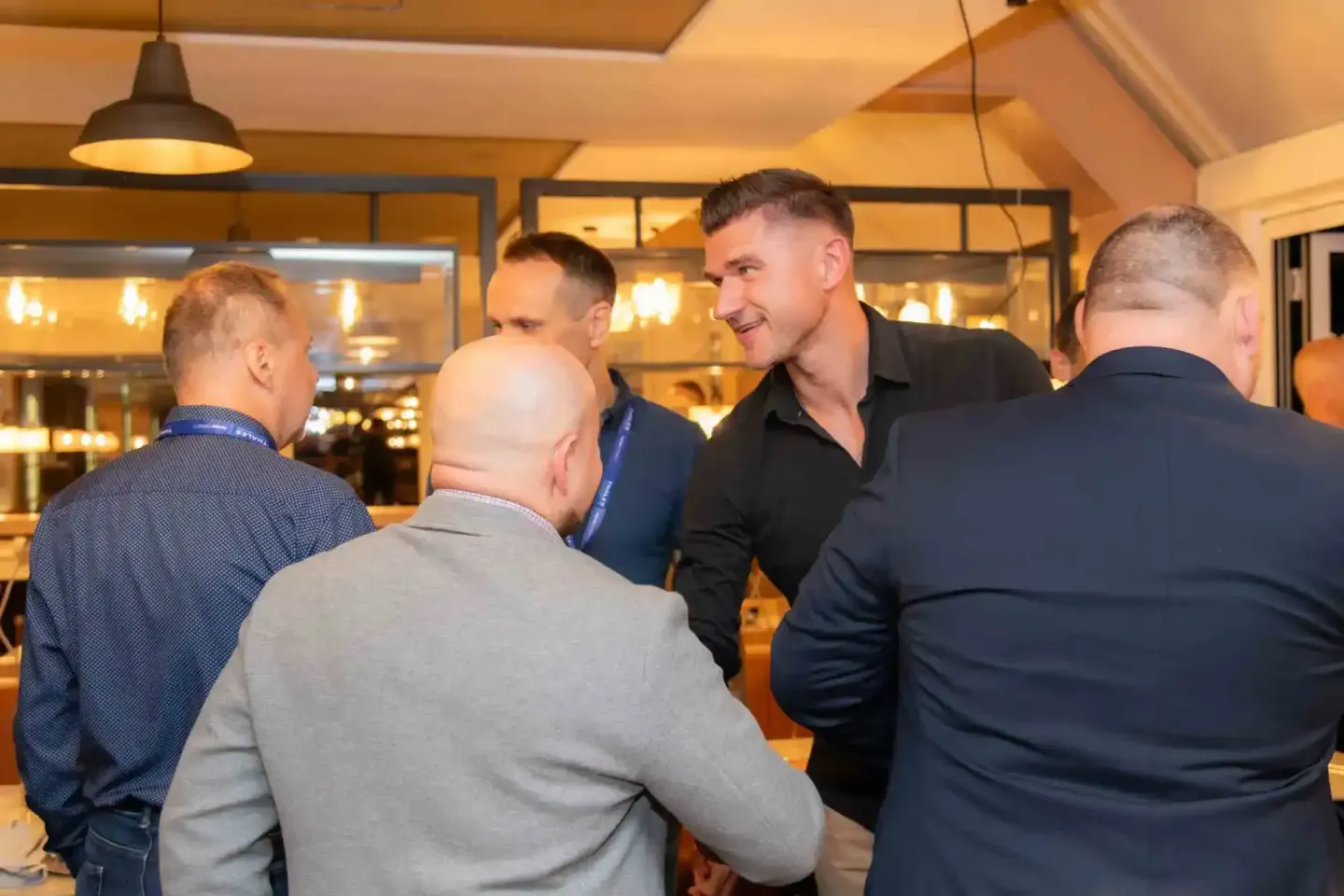 Geschäftsmänner im Gespräch bei einem Firmenevent Wien, professionelle Eventfotografie in modernem Ambiente