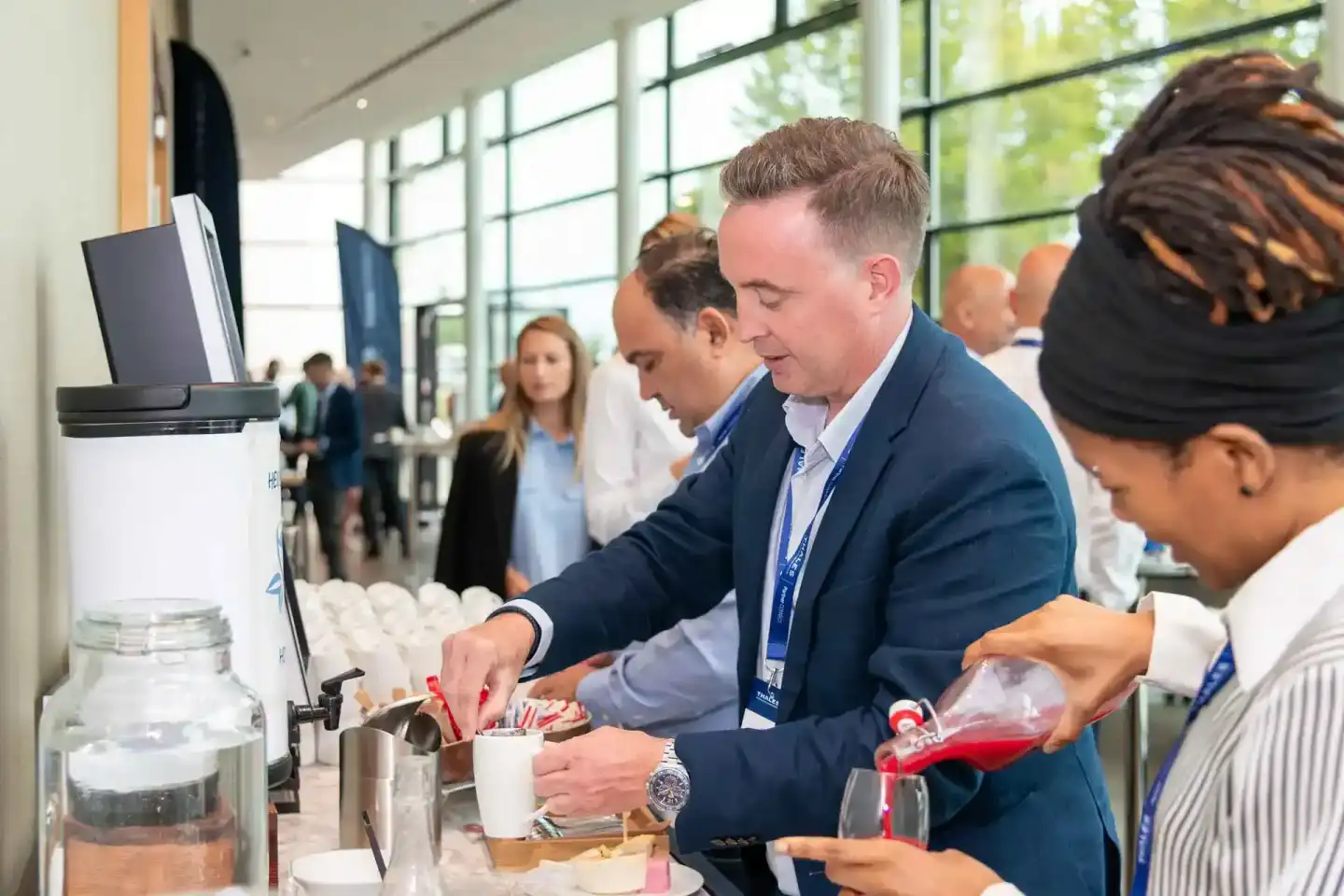 Eventfotograf Wien dokumentiert Geschäftsleute beim Netzwerken an einem Getränkestand während einer Firmenveranstaltung