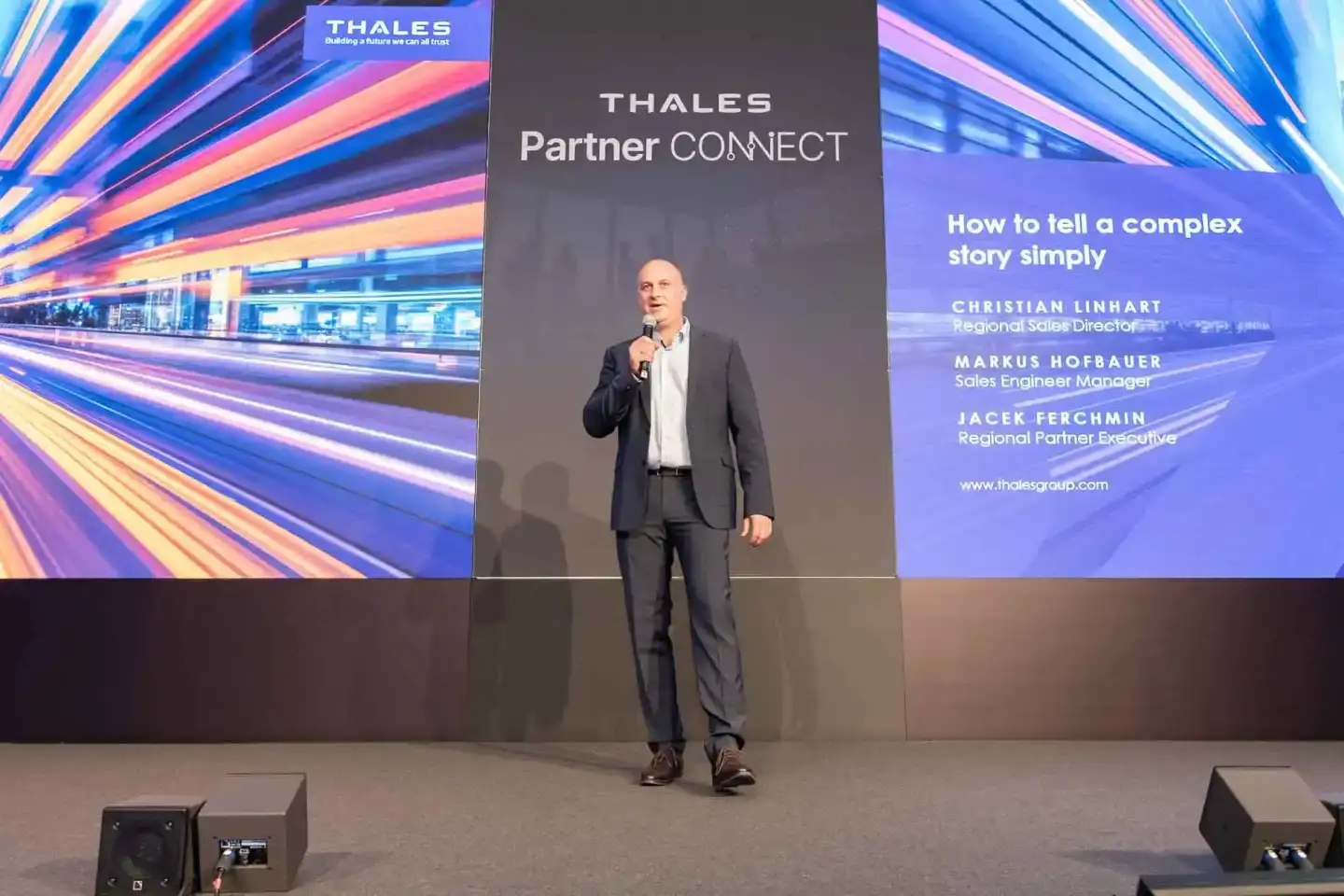 Redner auf der Bühne bei Thales Partner Connect Event Wien, Eventfotograf dokumentiert Präsentation