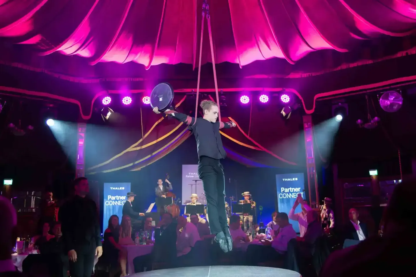 Akrobat schwebt an Seilen über Publikum bei Thales Firmenevent, professionelle Eventfotografie Wien